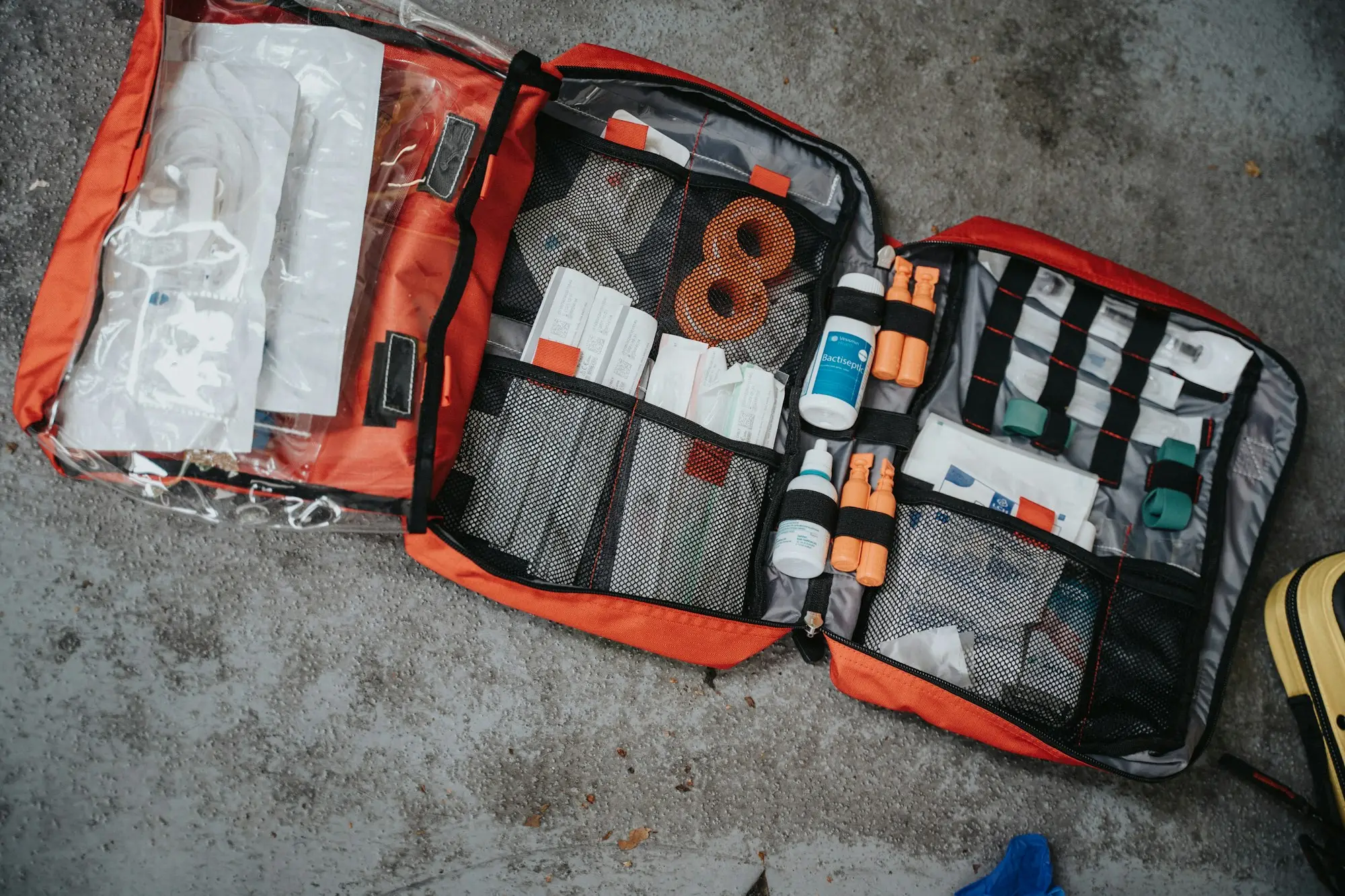 Emergency grab bag with first aid and documents laid out