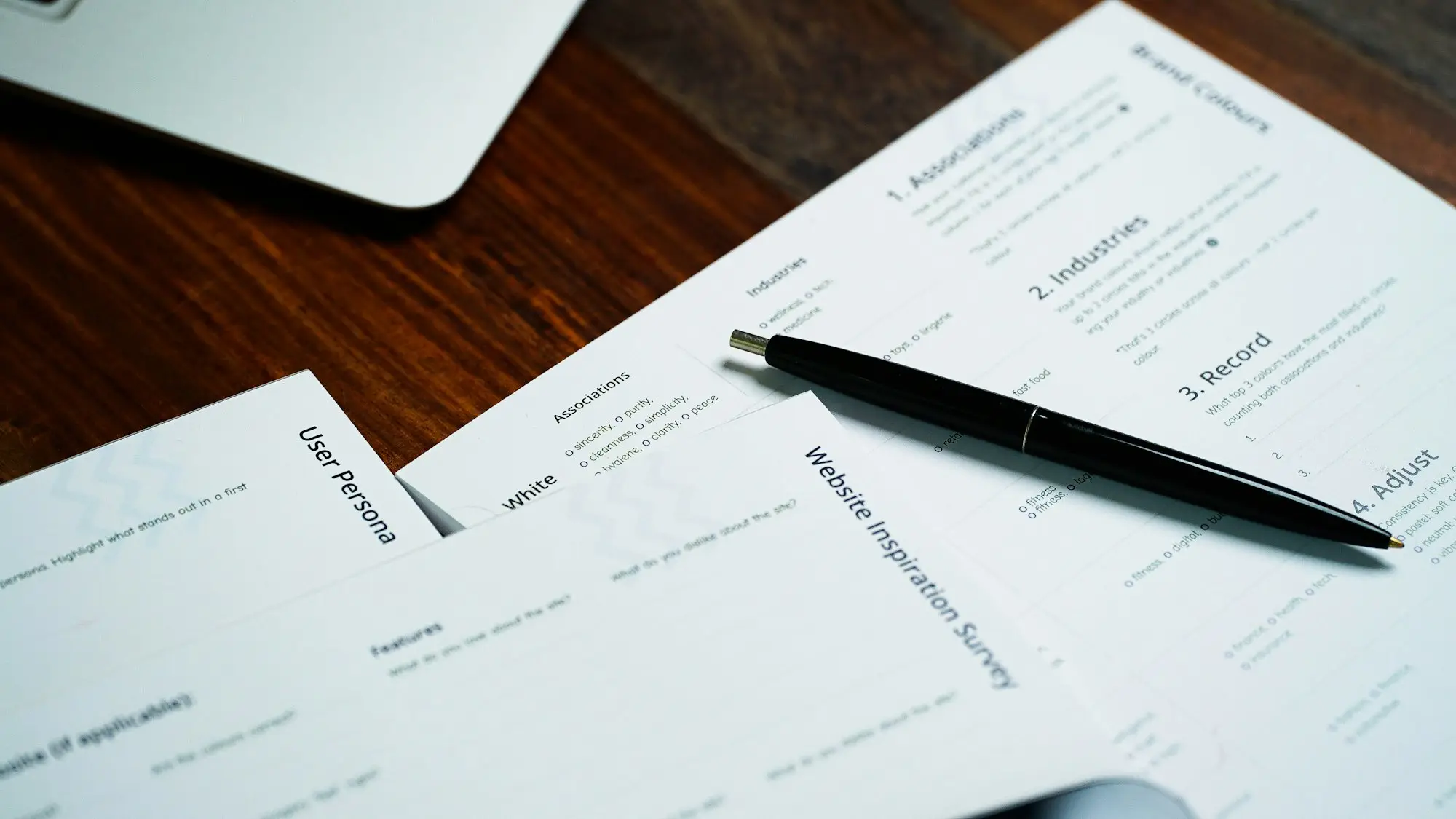 Insurance forms and a pen on a desk ready for review